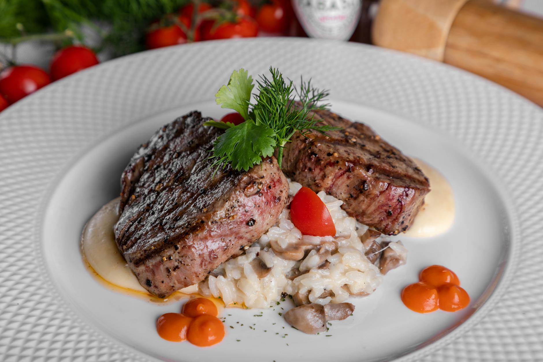 meat with sliced tomatoes on white ceramic plate
